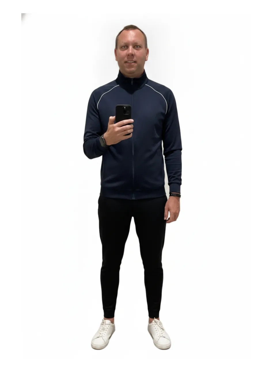 The founder restyled into a sport-luxe look — navy track jacket, joggers and white sneakers, rendered on his own photo.